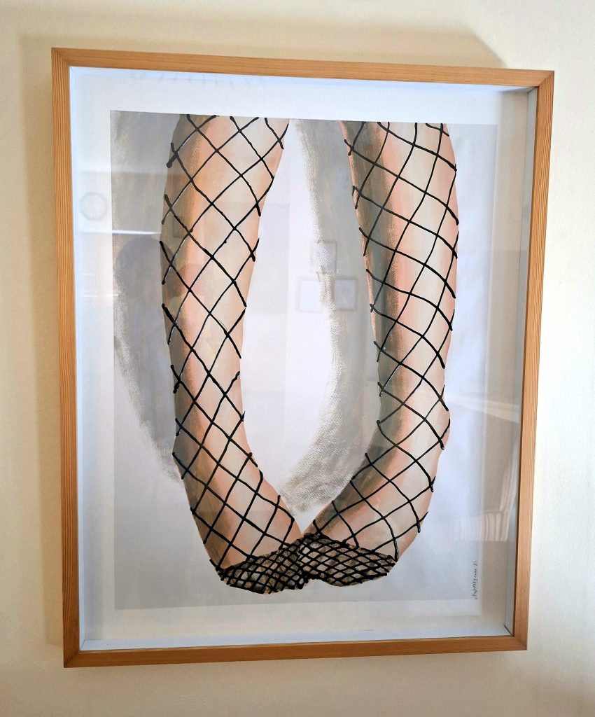 Roi Pajursky - Detailed black and white ink drawing on paper, framed, featuring a close-up, top-down view of a pair of female legs wearing fishnet or textured nylon stockings, rendered with a high-contrast pattern and meticulous detail.